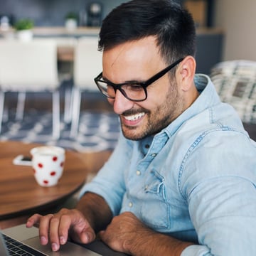 XYPN man with laptop smiling-square